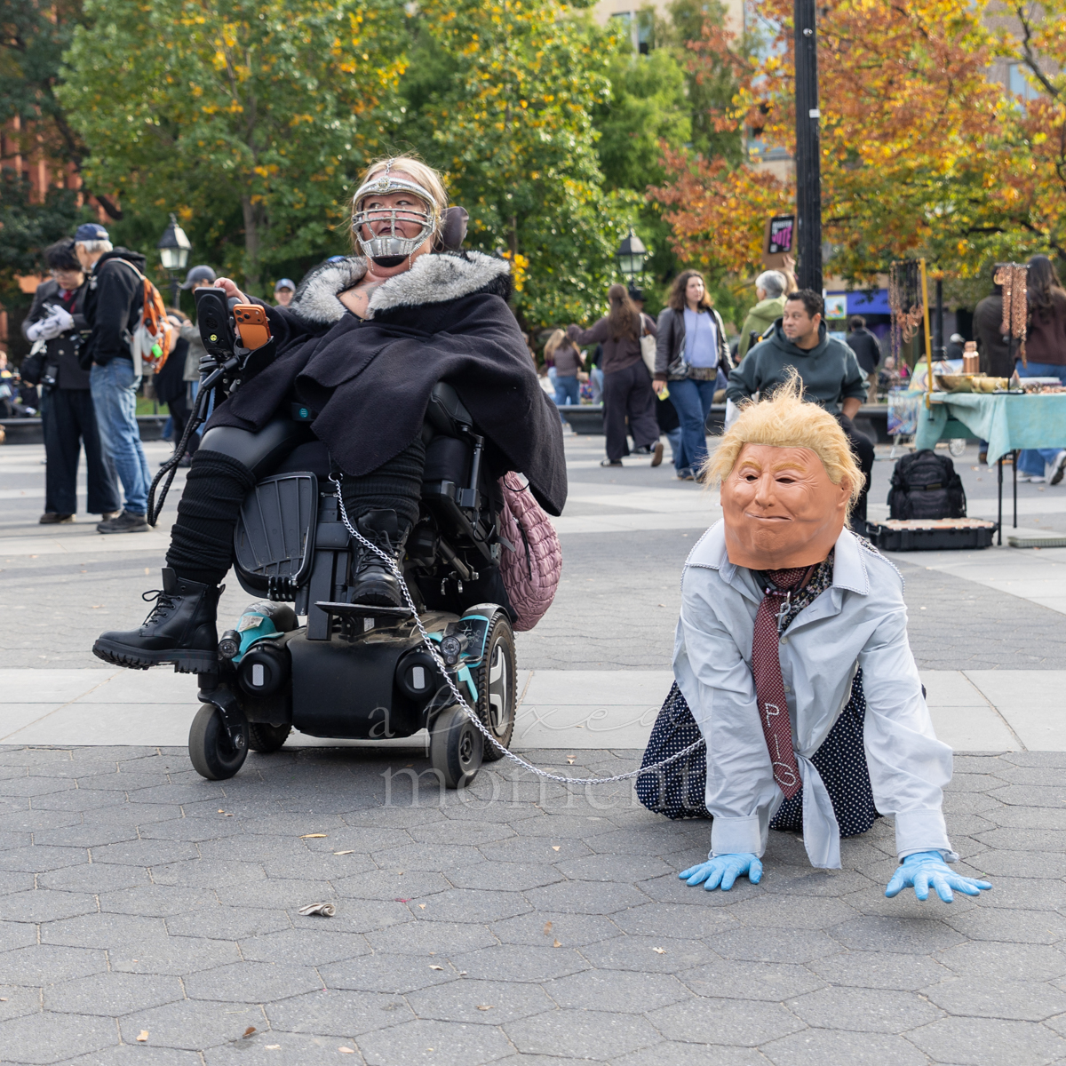 Participants stage a satirical scene involving a Trump mask and a chain.