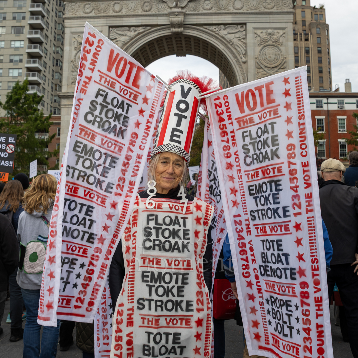 Voting messages cover an attendee’s tall hat and wearable panels.