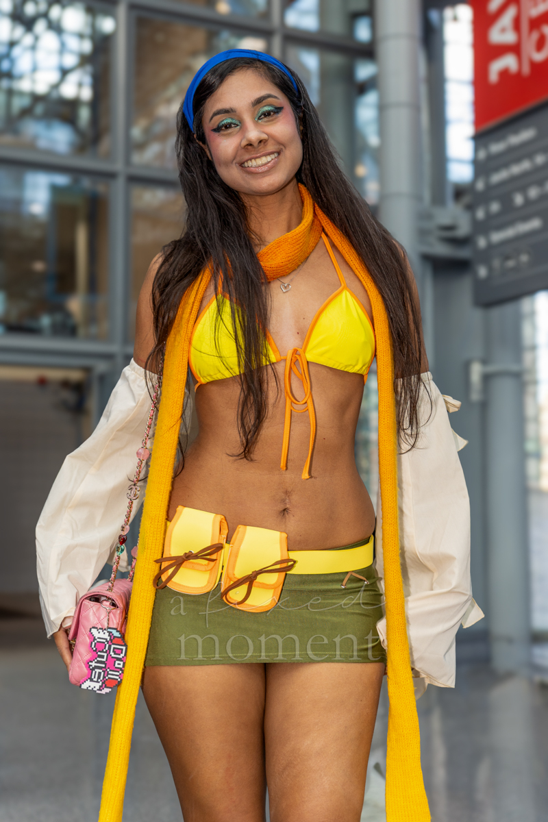 Cosplayer wearing a yellow top and green skirt at New York Comic Con 2026
