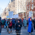 A large crowd of demonstrators moves through the streets of New York City during the 50 50 1 march on February 17, 2025, holding various protest signs addressing social and political issues. The protest, which started at Union Square and made its way to Washington Square Park, features a diverse group of participants dressed in winter clothing, including puffer jackets, hats, scarves, and gloves, as they march through a tree-lined street surrounded by historic red-brick buildings.
Among the many signs visible, some key messages include:
"THE UNITED STATES OF", followed by a list of diverse groups including immigrants, veterans, Muslims, Jews, Christians, atheists, Asians, Native Americans, whites, Blacks, Latinos, straights, gays, and trans people—a statement advocating for inclusivity.
"LISTEN FOR DANGEROUS WORDS", held by a protester wearing sunglasses and a black puffer jacket.
"PARA$ITE", with an illustration of a person depicted as a leech, held by a protester in a bright blue coat and orange beanie.
"SEND MUSK TO MARS", a sign criticizing Elon Musk.
Other signs reference fascism, impeachment, and corporate greed.
Protesters of various ages and backgrounds are engaged in conversation and marching with determined expressions. Some are capturing the moment with their phones, while others raise their signs high. The peaceful demonstration highlights issues of government accountability, social justice, and economic disparity, reflecting a broader movement pushing for change.