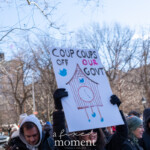 A demonstrator at the 50 50 1 march in New York City on February 17, 2025, holds up a protest sign with a hand-drawn cuckoo clock featuring Twitter bird logos and the phrase:
"COUP COUPS OFF OUR GOVT"
The sign is a clever play on words, referencing political coups and social media’s influence on government affairs. The person holding the sign wears a black puffer coat, black gloves, and sunglasses, with a determined expression as they raise their message high.
In the background, Washington Square Park is filled with other protesters, some dressed warmly in winter coats and hats, engaging in the demonstration. Bare trees and city buildings frame the scene, emphasizing the mid-winter setting of the protest.