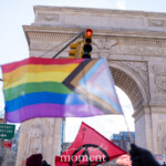 A Progress Pride Flag waves in the foreground as demonstrators gather under the Washington Square Arch in New York City during the 50 50 1 march on February 17, 2025. The flag, a symbol of LGBTQ+ inclusion and intersectionality, stands out against the historic monument, which commemorates George Washington’s inauguration.
Another flag, featuring an Extinction Rebellion logo in red and black, is also visible in the crowd, symbolizing environmental activism. The traffic light above glows red, a striking contrast to the movement below. In the background, a sign reads "Veterans Say No to Fascism," reinforcing the themes of resistance, democracy, and human rights.
This photograph captures the intersection of activism, identity, and history, with a powerful visual representation of diverse social movements uniting in protest.