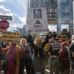 At the Picket Tesla protest organized by Rise and Resist (@risenresistnyc) on March 1, 2025, outside the Tesla Showroom at 860 Washington Street, NYC, a protester with long blonde hair, wearing a black outfit with yellow accents, raises a controversial sign that reads:
"GOES FROM 0 TO 1939 IN 3 SECONDS"
"TESLA: THE SWASTICAR"
The sign features an edited image of Elon Musk standing in a Tesla with a swastika symbol on the front, making a strong statement against Musk’s political influence and corporate practices.
To the left, a protester in a red coat and pink scarf holds a yellow sign stating:
"MUSK IS A SECURITY THREAT."
Behind them, a diverse crowd of demonstrators raises additional signs, including:
"OVERTHROW THE OLIGARCHS"
"THIS BILLIONAIRE IS STEALING FROM YOU."
"TAKE THE KEYS FROM..." (partially visible)
The setting includes modern glass skyscrapers and a street sign reading "STOP", symbolizing the protesters’ demand to halt Musk’s growing power. Sunlight filters through the scene, casting a dramatic glow on the demonstrators.
The Rise and Resist (@risenresistnyc) protest focuses on economic justice, corporate accountability, and resistance to authoritarianism, using bold imagery and powerful rhetoric to highlight concerns about billionaires' political influence.