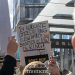 At the Picket Tesla protest organized by Rise and Resist (@risenresistnyc) on March 1, 2025, outside the Tesla Showroom at 860 Washington Street, NYC, demonstrators rally with bold signs against Elon Musk's influence, corporate power, and political entanglements.
A prominent white sign with black lettering reads:
"THIS MUSK BE STOPPED!"
It is held high amidst a sea of protest placards. In the lower left, another demonstrator raises a yellow and blue sign reading "SLAVA UKRAINI", expressing solidarity with Ukraine. Additional signs in the crowd reinforce the message of corporate and political resistance, including:
"OVERTHROW THE OLIGARCHS"
"MAKE NO MISTAKE, THIS IS A COUP"
"THIS BILLIONAIRE STOLE YOUR SOCIAL SECURITY NUMBER"
The backdrop of red brick buildings, a blue sky, and a "STOP" street sign visually underscores the urgency of the demonstration. A cardboard cutout of a raised fist, symbolizing resistance and defiance, is also visible.
This demonstration by Rise and Resist (@risenresistnyc) brings together economic justice activists, political critics, and international solidarity movements, connecting corporate accountability with global issues. The mix of messages, from economic concerns to geopolitical activism, reflects the broad scope of the protest.