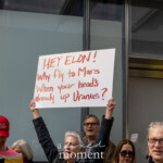 At the Picket Tesla protest organized by Rise and Resist (@risenresistnyc) on March 1, 2025, outside the Tesla Showroom at 860 Washington Street, NYC, a demonstrator raises a handmade white sign with red lettering, reading:
"HEY ELON!
Why fly to Mars
When your head’s already up Uranus?"
The sign humorously critiques Elon Musk's space ambitions, particularly with SpaceX, while serving as a broader critique of his influence in politics, business, and technology.
The protester, an older woman with short gray hair, holds the sign high, standing among a crowd of diverse demonstrators. In the background, another protester wears a red hat with the words "FK TRUMP"**, reinforcing the political tone of the event. Additional signs, including one with a crossed-out Tesla logo, indicate a widespread boycott of Musk-owned companies. The setting outside the Tesla showroom creates a direct confrontation between corporate power and public activism.
The Rise and Resist (@risenresistnyc) demonstration blends political criticism, economic activism, and satirical commentary, using creative and provocative messaging to amplify concerns about wealth inequality, corporate influence, and democratic accountability.