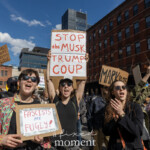 At the Picket Tesla protest organized by Rise and Resist (@risenresistnyc) on March 1, 2025, outside the Tesla Showroom at 860 Washington Street, NYC, a group of demonstrators energetically chant and raise their signs, expressing resistance against Elon Musk, Donald Trump, and corporate authoritarianism.
In the center, a woman in black sunglasses and a black top raises a handmade sign reading "STOP the MUSK TRUMP COUP", while another protester next to her holds a sign that reads "FASCISTS ARE FUGLY!". Their open-mouthed expressions convey urgency and defiance.
Surrounding them, additional demonstrators display signs with messages including:
"NO KINGS, NO COUPS, FASCISTS ALWAYS LOSE"
"TRUMP VANCE ARE THUGS"
"MARK 10:25" (A biblical reference likely critiquing wealth and power)
The protesters' attire varies from casual to colorful, with sunglasses, patterned jackets, and bold accessories. Their raised fists and animated facial expressions underscore the passion and intensity of the demonstration. The red brick buildings and blue sky in the background enhance the visual contrast of the scene, framing the protesters as a forceful presence in the streets of Manhattan.
This demonstration by Rise and Resist (@risenresistnyc) unites political activists, economic justice advocates, and anti-authoritarian demonstrators in a rally against billionaire influence, corporate greed, and right-wing politics, with a focus on Elon Musk’s expanding political role.