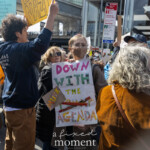 A protester holds a handmade sign reading "DOWN WITH THE MUSK AGENDA" at the Picket Tesla protest outside the Tesla Showroom at 860 Washington Street, NYC, on March 1, 2025. The sign is decorated with bold, colorful letters, with "Musk" crossed out in yellow. The activist, wearing glasses, a brown coat, and a protective face mask, stands firmly in a crowd of demonstrators raising their voices against Elon Musk’s political and corporate influence.
In the background, a diverse group of protesters holds various signs condemning billionaire control, corruption, and corporate overreach. The event, organized by Rise and Resist NYC (@riseandresistnyc), brought together people advocating for economic justice and democratic integrity.
The Resistance Revival Chorus (@resistancerevivalchorus) also participated, using music to amplify the protest’s message. This moment captures the determination and unity of grassroots activism, as demonstrators continue to push for accountability and systemic change.