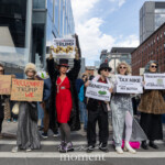 A group of demonstrators at the Picket Tesla protest outside the Tesla Showroom at 860 Washington Street, NYC, on March 1, 2025, perform a satirical act as "Trillionaires for Trump", mocking wealth inequality and corporate greed. Dressed in extravagant outfits, including fur coats, sequined dresses, pearls, and top hats, they hold ironic protest signs exposing how billionaire tax policies favor the ultra-wealthy at the expense of ordinary citizens.
The signs read:
"Let them eat cake!"
"Trillionaires for Trump – Even WE can't afford eggs!"
"Your benefits will fund my golf lessons."
"Your tax hike will fund my Botox."
"Your prescriptions will fund my Birkin bag."
One protester raises a sign featuring golden coins with the words "Trillionaires for Trump", further emphasizing the message that billionaires and corporate elites benefit from policies that harm working-class people.
This performance-style protest was part of an action organized by Rise and Resist NYC (@riseandresistnyc), aiming to draw attention to economic injustice, wealth hoarding, and corporate power. The event also featured the Resistance Revival Chorus (@resistancerevivalchorus), blending activism with creative expression to amplify their message.