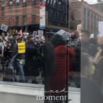 At the Picket Tesla protest outside the Tesla Showroom at 860 Washington Street, NYC, on March 1, 2025, an NYPD officer is seen arresting a protester and escorting him towards a police van as the crowd looks on. The protester, wearing a harlequin-patterned shirt, is flanked by officers while demonstrators continue to hold signs and chant against Elon Musk, corporate greed, and political influence.
The scene is captured through the glass reflections of the Tesla showroom, blending the interior of the high-tech retail space with the protest and law enforcement presence outside. Signs reading "Make No Mistake, This is a Coup!" and "Boycott Tesla" are visible in the background, reinforcing the demands of the demonstration organized by Rise and Resist NYC (@riseandresistnyc).
The arrest symbolizes a moment of heightened tension, as police move in to enforce order while demonstrators push back against what they view as billionaire overreach and corporate complicity in authoritarian politics.
