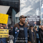 A group of protesters gathers outside the Tesla Showroom at 860 Washington Street, NYC, on March 1, 2025, as part of the Picket Tesla protest organized by Rise and Resist NYC (@riseandresistnyc). A man in a blue quilted jacket, adorned with various activist buttons, passionately chants while holding a sign that reads “THIS IS THE IMMIGRANT WHO TOOK YOUR JOB” featuring an image of Elon Musk pointing.
Around him, several other demonstrators raise bold signs, including one that says "MUSK IS STEALING FROM YOU" and another controversial sign in large yellow letters reading “KILL NAZIS.” The energy of the protest is intense, with people raising their fists and voices in defiance of Musk’s business practices and political influence. The NYPD officers in the background monitor the demonstration, standing near the crowd.
The protest, which focused on economic inequality, corporate power, and Elon Musk’s political influence, saw activists demanding accountability and economic justice.