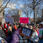 A large, spirited crowd gathers at the Women's March held on March 8th, 2025, at Washington Square Park, New York City. The demonstrators enthusiastically hold up various handmade protest signs, advocating for women's rights, political change, and reproductive justice. Several powerful messages are clearly visible:
"I'd call TRUMP a CUNT but he lacks depth + warmth."
"RAPISTS Belong in Jail Not the OVAL OFFICE"
"Protect Democracy"
"'Calladita' Didn't Make Me Más Bonita, It Made Me Obedient and Obedient Never Changed The World. @Unapologetically.latina"
The participants wear warm attire suited to the March weather, with jackets, scarves, sunglasses, hats, and gloves. The setting is energized, filled with a diverse, determined crowd uniting their voices and messages for social justice and equality at Washington Square Park, New York City, during the Women's March on March 8th, 2025.