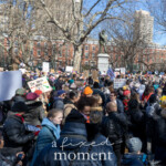 A panoramic photograph vividly captures a massive and diverse assembly of demonstrators gathered for the Women's March on March 8th, 2025, at Washington Square Park in New York City. The enthusiastic crowd densely fills the park, with numerous activists proudly raising a multitude of colorful and bold protest signs, passionately advocating for women's rights, reproductive justice, political accountability, and social change.
Some clearly visible protest signs among the crowd include empowering phrases and messages such as:
"I'M WITH HER"
Messages about reproductive justice, women's rights, and anti-patriarchy sentiments.
The participants, of various ages and backgrounds, are dressed warmly in coats, jackets, hats, and scarves to brave the early March weather. The vibrant atmosphere highlights their unified voice, solidarity, and determined activism to promote equality, social justice, and reproductive rights.