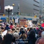 A large crowd of demonstrators fills Union Square in New York City during the Women's March on March 8, 2025. Protesters are seen holding up various signs advocating for feminism, equality, and resistance against oppression. Among the visible signs, one reads "FEMINISM NOT FASCISM", while another states "FEMINISM ALREADY DEFEATED GREED".
The energy of the protest is palpable as individuals of diverse backgrounds, wearing colorful hats, scarves, and jackets suitable for the chilly weather, stand together in solidarity. Some participants are engaged in conversations, while others focus on listening to speakers addressing the crowd via a loudspeaker in the background. The cityscape of Union Square, including street signs for Broadway and University Place, is visible, along with a public art installation on the side of a building.
This moment captures the resilience and activism of those standing up for women's rights, gender equality, and broader social justice causes.