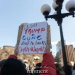 A demonstrator at the Women's March 2025 in Union Square, NYC, raises a provocative sign with bold red and blue lettering that reads:
"I’d call TRUMP a C**T but he lacks Depth + Warmth."
The individual holding the sign is wearing a red jacket, with their hand firmly gripping the protest sign. The background is filled with other demonstrators holding signs, high-rise buildings, and streetlights lining Union Square. The crowd consists of people of various backgrounds, all gathered in solidarity for women’s rights and political activism.
The sign’s sharp political statement reflects the strong emotions and discourse surrounding the march, highlighting issues of leadership, democracy, and feminist resistance. The energy of the crowd, along with the urban backdrop, captures the spirit of activism and protest in New York City.